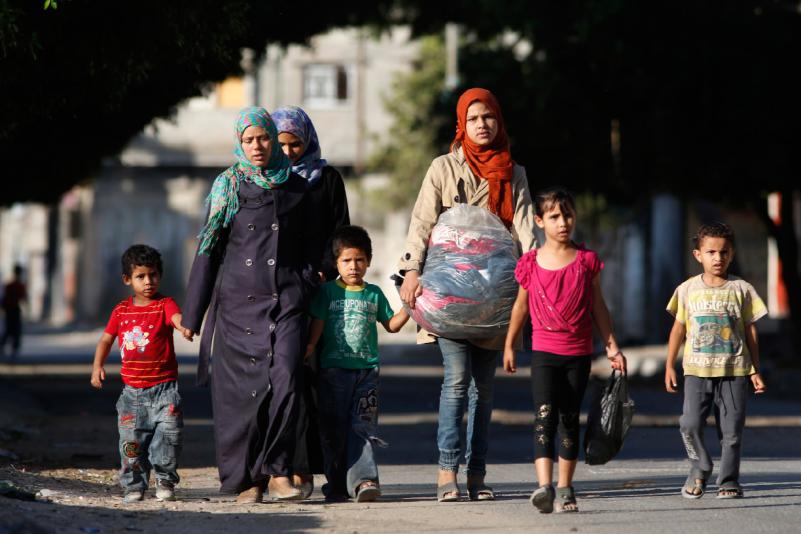 A Palestinian family flees their home after receiving a 'warning missile' to evacuate their home - Google Images